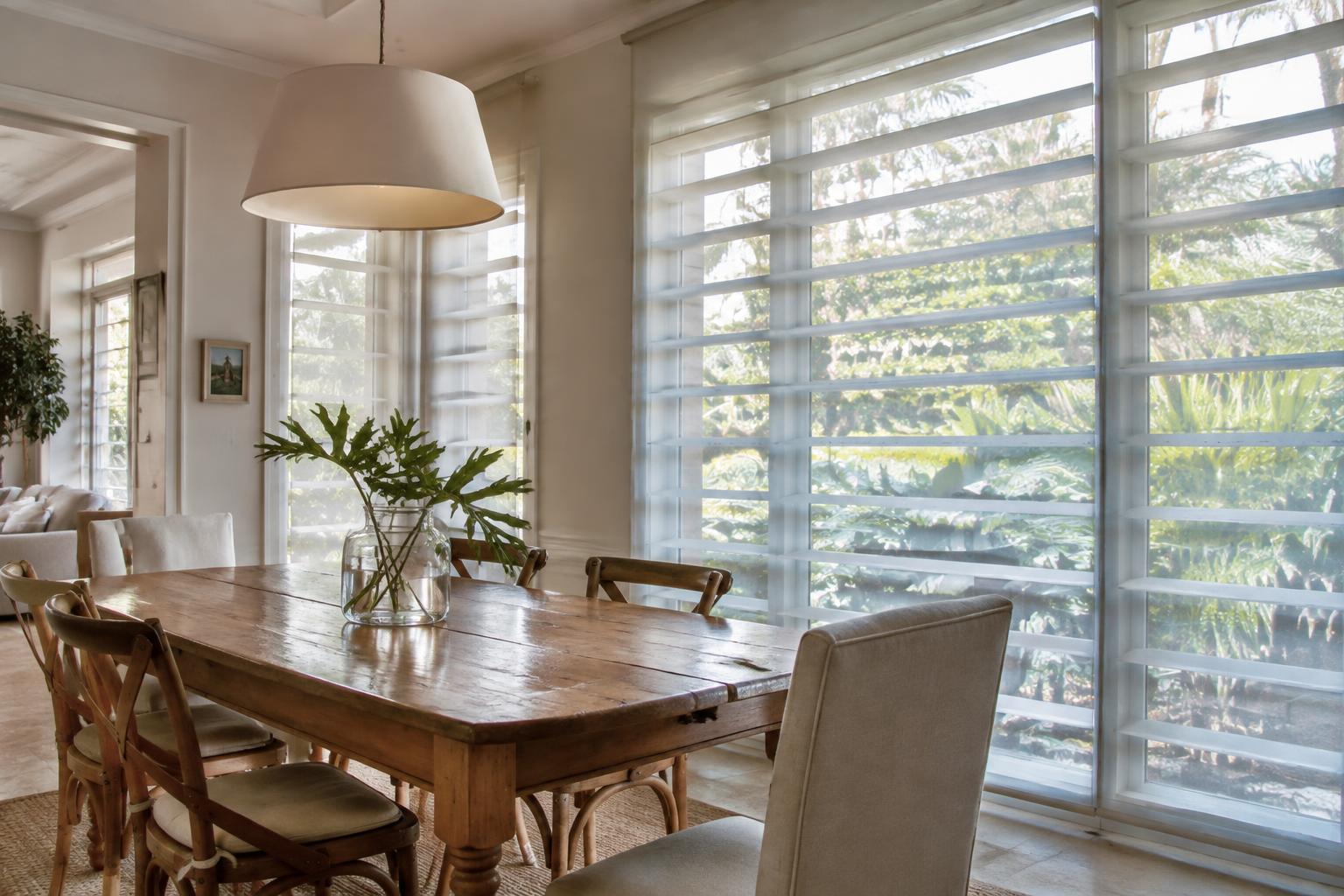Sheer shades filtering daylight in a South Florida dining room